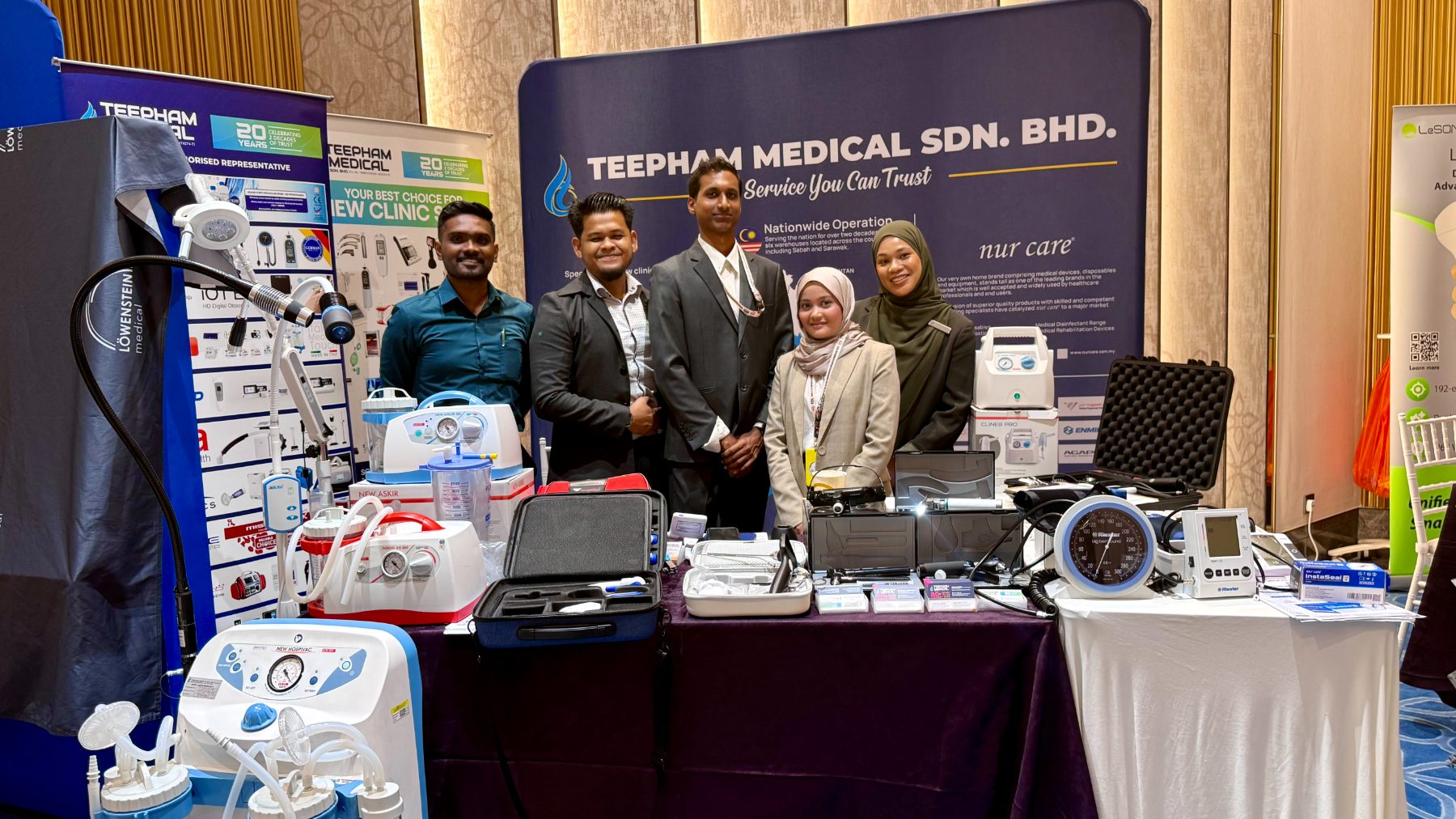 Teepham Medical exhibition stand showing suction units, nebulisers, otoscopes and blood pressure monitors with the team