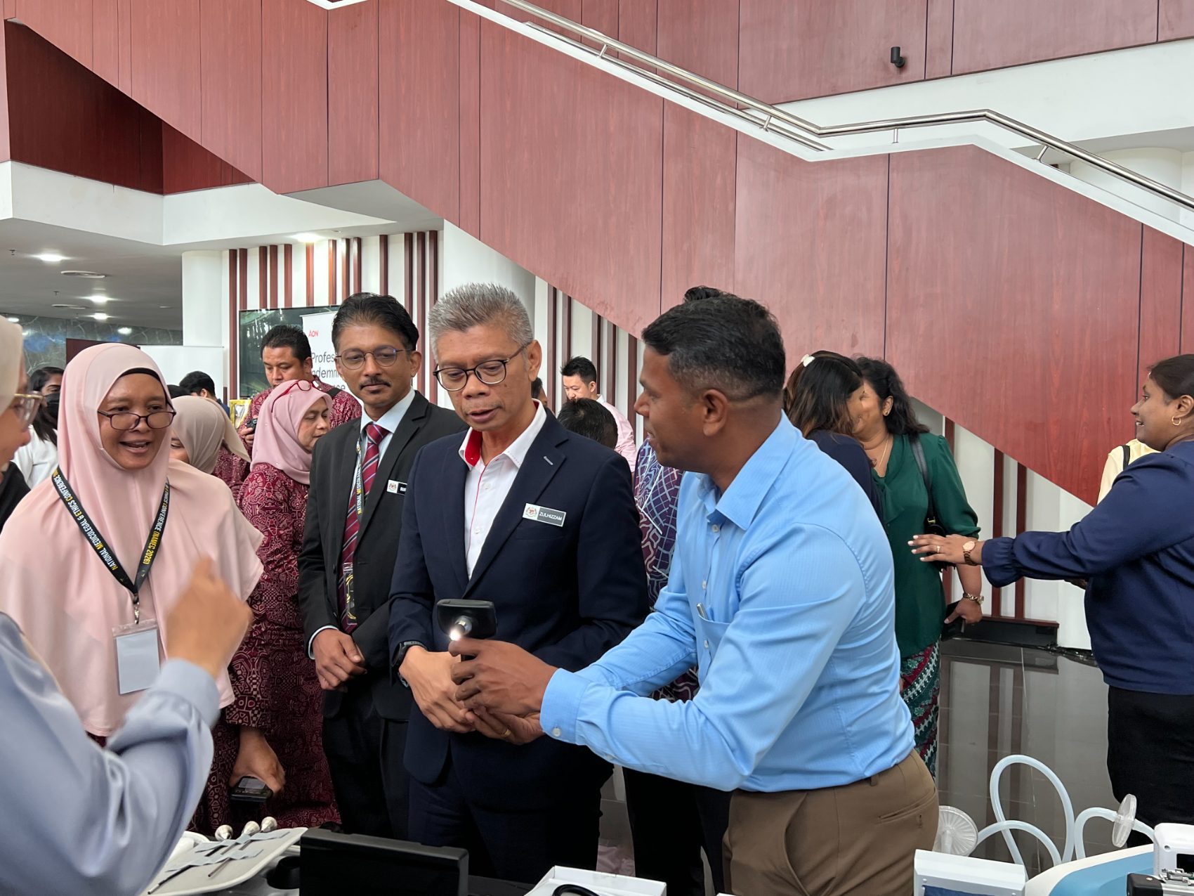 A Teepham representative demonstrating a digital otoscope to delegates at a national medical conference