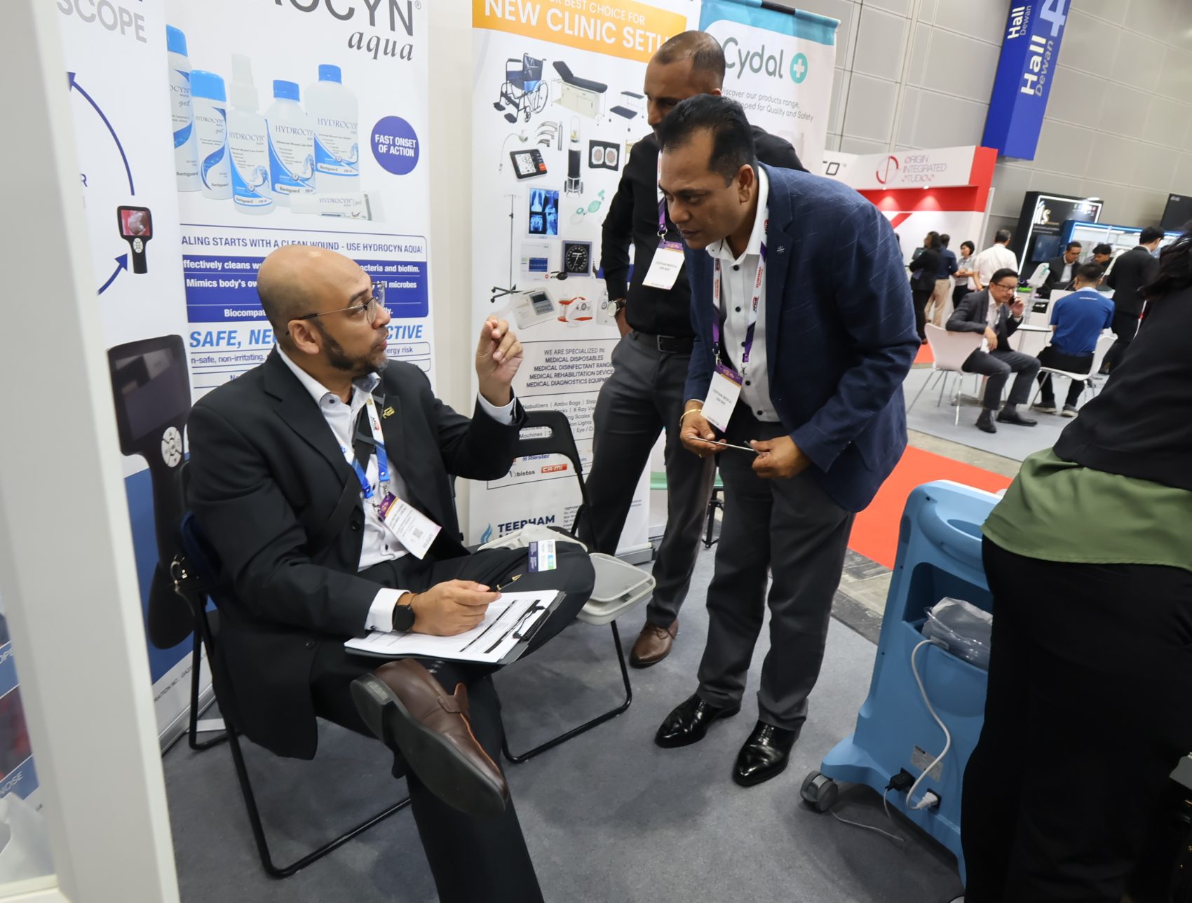 A Teepham representative going through equipment paperwork with a doctor at a new-clinic-setup consultation