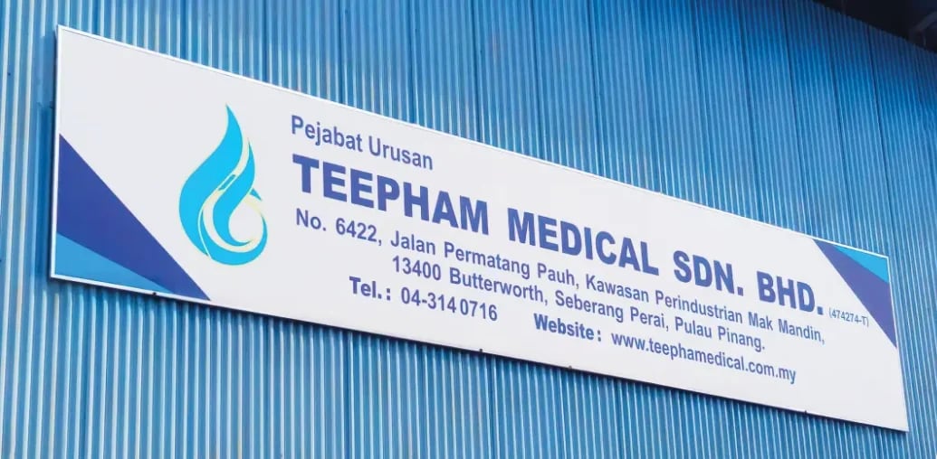 Teepham Medical's Penang business office signboard on the blue corrugated wall of the Butterworth premises